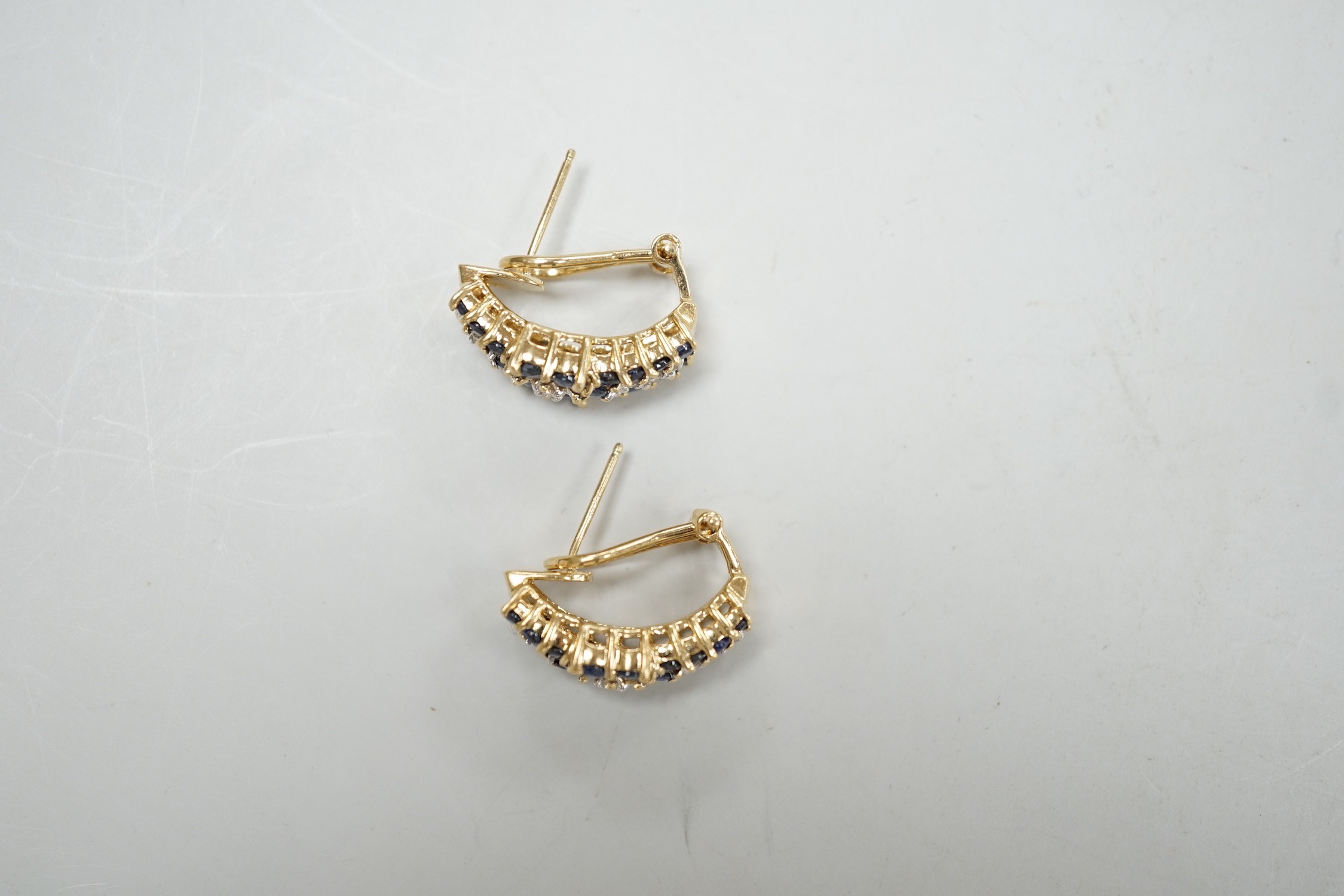 A modern pair of 14k yellow metal, sapphire and diamond cluster set demi-lune earrings, 19mm, gross weight 7.4 grams.